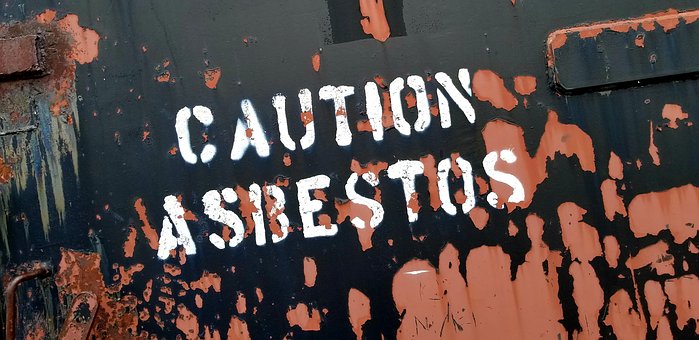 A close up of the words caution asbestos